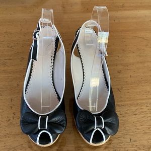 Platform leather and jute wedge sling backs, piped with bow and peep toe.